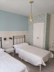 Posteľ alebo postele v izbe v ubytovaní Hostal Quiper