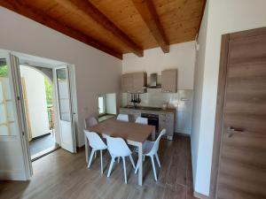 a kitchen and dining room with a wooden table and chairs at Al Monumento casa vacanze in Amantea
