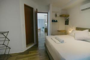 a bedroom with a white bed and a balcony at HotelZone L20 Beach Access in Cancún +55 photos