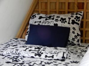 a bed with a black and white blanket and a pillow at Eco Camping Jarabacoa in Jarabacoa +40 photos