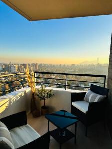 a balcony with couches and a view of a city at LUUM by Norus in Santiago