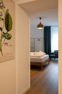 a room with a bed and a mirror at ღLiboria I Casa Mangifera in Murnau am Staffelsee +23 photos