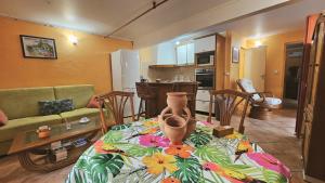 a living room with a couch and a table at Pieds dans l'eau F2 pointe du bout trois-Ilets in Lazaret