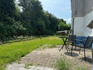 a table and two chairs sitting next to a field at Tiny House mit Wohnfass in Diez