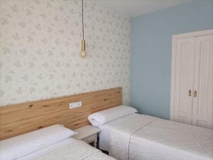 Posteľ alebo postele v izbe v ubytovaní Hostal Quiper