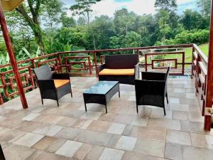 a patio with chairs and a couch and a table at Villas Carari 2 in Savegre