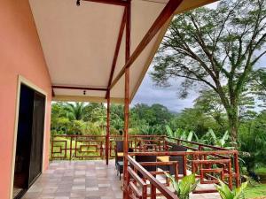 a porch with benches and a view of the forest at Villas Carari 2 in Savegre
