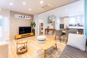a living room with a couch and a table at Beppu ZEN in Beppu