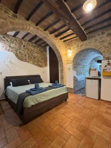 a bedroom with a bed in a stone wall at Casa Leon - City center in Perugia