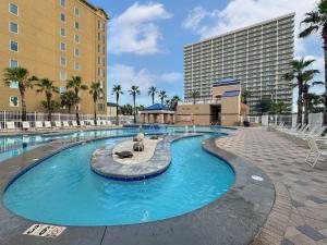 a large swimming pool in front of a hotel at Sunset Crossing in Gulf Shores