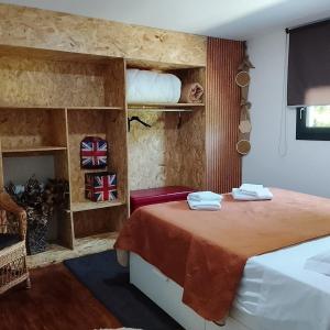 a bedroom with a bed with towels on it at Alojamento 444 in Monção