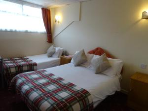 a hotel room with two beds and a window at The Belvedere in Blackpool