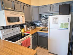 a kitchen with a white refrigerator and a sink at Ocean Front Paradise 364 in North Topsail Beach