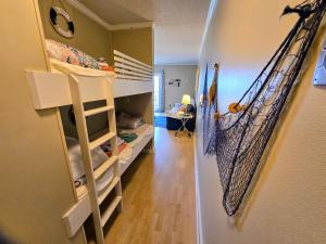 a room with a bunk bed and a hallway at Ocean Front Paradise 364 in North Topsail Beach
