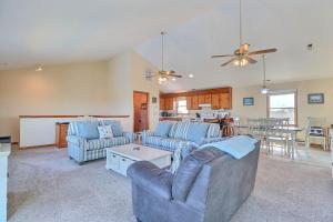a living room with two couches and a kitchen at 5042 - Beachside Hangar in Kill Devil Hills +31 photos