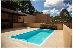 a swimming pool in the backyard of a house at Hotel Mr Lion and SPA in Bernal
