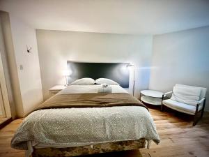 a bedroom with a large bed and a chair at Beautiful and cozy room in Vancouver in Vancouver