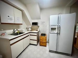 a kitchen with a refrigerator and a sink at Beautiful and cozy room in Vancouver in Vancouver