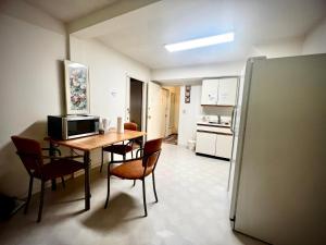 a kitchen with a table and chairs and a refrigerator at Beautiful and cozy room in Vancouver in Vancouver
