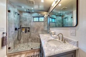 a bathroom with a shower and a sink at Koda House in Lake Arrowhead +21 photos