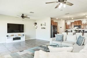 a living room with a white couch and a tv at GoldStar Luxury Home in Ruskin