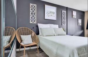 a bedroom with a bed and two chairs at Providence Place in Clarksville