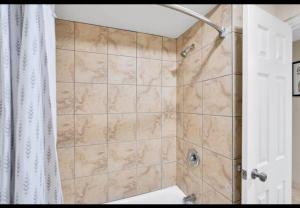 a bathroom with a shower with a shower curtain at Providence Place in Clarksville