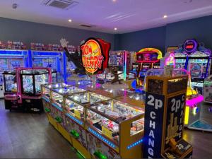 a room with many arcade games and video games at The Rainbow's nest in Morecambe
