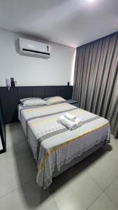 a bedroom with a bed with towels on it at #FLAT425 Get One - João Pessoa - Brasil in João Pessoa