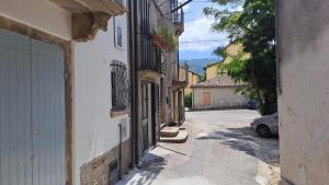 an alley with buildings and a car on a street at Casa Tucci b&b in Serra San Bruno