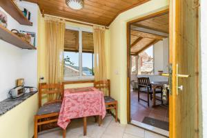 a room with a table and chairs and a dining room at Seaside holiday house Igrane, Makarska - 24635 in Podgora