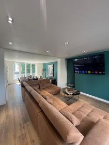a large long couch in a living room at Villa L'Etoile Du Littoral in Boulogne-sur-Mer