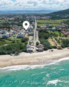 an aerial view of a beach with a white dot at Pousada Marina do Sol in Florianópolis