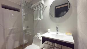 a bathroom with a toilet and a sink and a mirror at La Casa del Viajero in Lima +105 photos