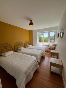 a room with four beds and a window at Villa L'Etoile Du Littoral in Boulogne-sur-Mer