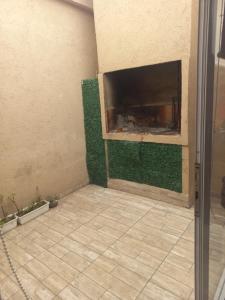 a living room with a fireplace with green walls at Maryhouse2 in Lomas de Zamora +7 photos
