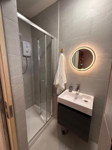 a bathroom with a shower and a sink and a mirror at 124B Modern Suite 1 bedroom apartment in Quinton