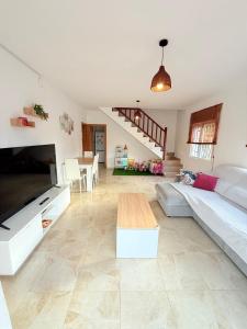 a living room with a couch and a table at Villa del sol in Creixell