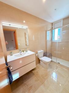 a bathroom with a toilet and a sink and a shower at Villa del sol in Creixell +25 photos