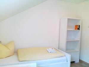 a room with a bed and a book shelf at Villa Caprivi - 12 in Heringsdorf