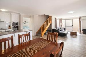 a kitchen and a living room with a table and a couch at Marina Family Beachscape in Geographe