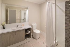 a bathroom with a toilet and a sink and a shower at Marina Family Beachscape in Geographe +6 photos