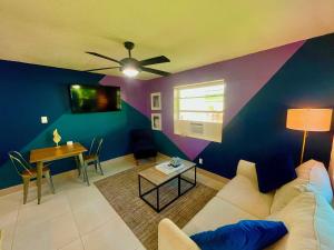 a living room with a couch and a table at SuaveMauve Las Olas Beach in Fort Lauderdale