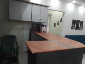a kitchen with a wooden counter top and a chair at شقه فندقيه in Sheikh Zayed +4 photos