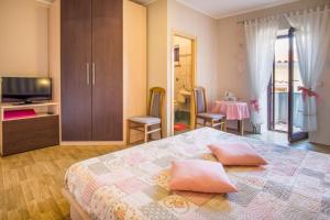 a bedroom with a bed with two pillows on it at Apartments & Rooms Iva in Vrbnik