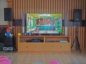 a entertainment center with a television in a living room at Oak Lawang in Lawang