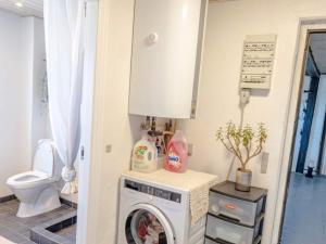 a washer and dryer in a bathroom with a toilet at 6 person holiday home in Vestervig in Vestervig +47 photos