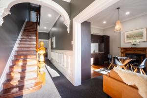 a staircase in a home with a living room at The Stuart Street Terraced House in Dunedin