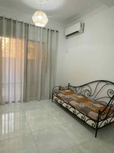 a bedroom with a bed in a white room at Dar El Emir in Annaba