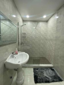 a white bathroom with a sink and a shower at Dar El Emir in Annaba +8 photos